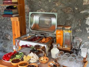 a table with a tray of food and a tv at Vila Shkalla in Theth