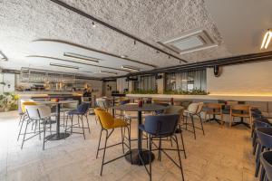 a restaurant with tables and chairs and a counter at Green Hotel in Genk