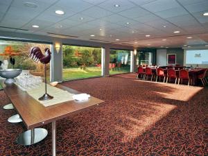a conference room with a table and chairs in it at Mercure Bourg En Bresse in Bourg-en-Bresse
