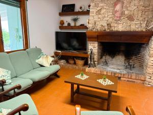 a living room with a couch and a fireplace at Masia Garridells in L'Ampolla
