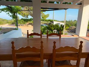 a dining room table with a view of the ocean at Masia Garridells in L'Ampolla