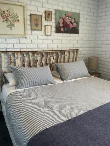 a bed with two pillows in a bedroom at Bruny Sunset Beach in Alonnah