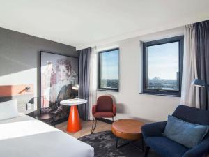 a hotel room with a bed and a chair at Mercure Amsterdam City Hotel in Amsterdam +162 photos