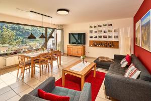 a living room with a couch and a table at Wohnen am Weingut - Bei den Weinbergen in Briedel