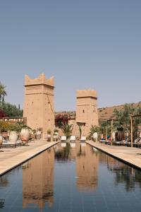 a pool of water in front of a building at Kasbah Beldi in Lalla Takerkoust