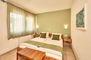 a bedroom with a large bed and a window at Wohnen am Weingut - Bei den Weinbergen in Briedel
