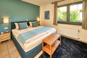 a bedroom with a large bed and a window at Wohnen am Weingut - Bei den Weinbergen in Briedel