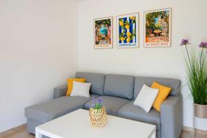 a living room with a blue couch with orange pillows at Vacation apartments Mario with salt water pool in Turjaci