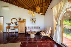 a living room with a couch and a table at Breath House Penida in Polilit +74 photos