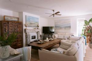 a living room with two couches and a fireplace at The Hamptons Beach House in East Preston