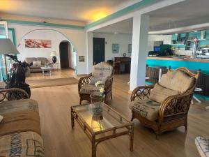 a living room with chairs and a coffee table at Es Raco de Canyamel in Canyamel