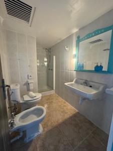 a bathroom with a toilet and a sink and a mirror at Es Raco de Canyamel in Canyamel +38 photos