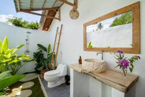 a bathroom with a sink and a toilet at Breath House Penida in Polilit