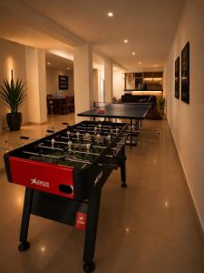 a row of ping pong tables in a room at AINO Hotel in Pilipets