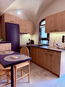 a kitchen with a table and a small table in it at Arch Residence, studio 2, Emporios in Katarráktis