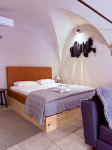 a bedroom with a bed and a blue chair at Arch Residence, studio 2, Emporios in Katarráktis