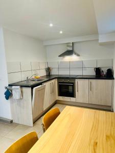 a kitchen with a wooden table and chairs in it at Guest-studio in Fribourg