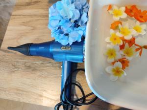 a blue pen sitting on top of a plate with flowers at The Shore Residence in Hikkaduwa +13 photos
