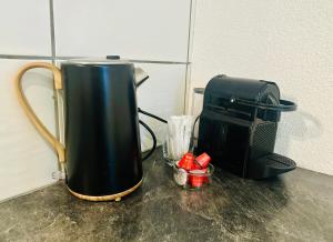 a coffee maker and a coffee pot on a counter at Guest-studio in Fribourg