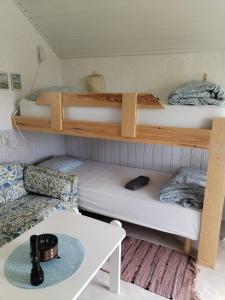 a room with two bunk beds and a table at The little cottage in Saltvik