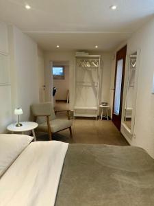 a bedroom with a bed and a living room at Guest-studio in Fribourg