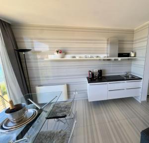 a kitchen with a glass table and a sink at St.Barth Apartments in Šibenik +7 photos