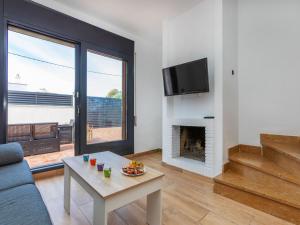 a living room with a couch and a fireplace at Villa Calas III by Interhome in L'Ametlla de Mar