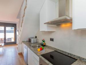 a kitchen with a sink and a microwave at Villa Calas III by Interhome in L'Ametlla de Mar