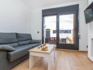 a living room with a couch and a coffee table at Villa Calas III by Interhome in L'Ametlla de Mar