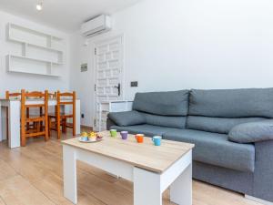 a living room with a couch and a table at Villa Calas III by Interhome in L'Ametlla de Mar +25 photos