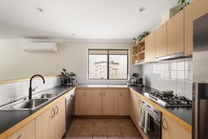 a kitchen with a sink and a window at Villa 11 Margaret River Beach House in Margaret River Town