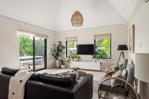 a living room with a couch and a tv at Villa 11 Margaret River Beach House in Margaret River Town +22 photos