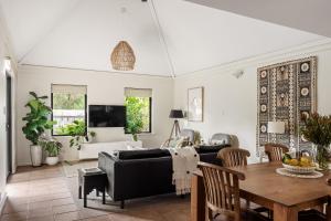 a living room with a couch and a table at Villa 11 Margaret River Beach House in Margaret River Town