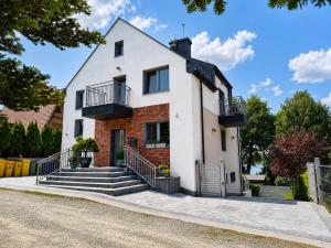 a house with stairs in front of it at Willa na Orlej in Giewartów
