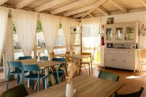 a kitchen and dining room with wooden tables and chairs at B&B La Vigna in Carovigno