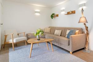 a living room with a couch and a table at Fischerhus Laboe in Laboe +37 photos