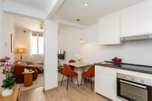a kitchen and living room with a table and chairs at Barbieri III in Madrid +11 photos