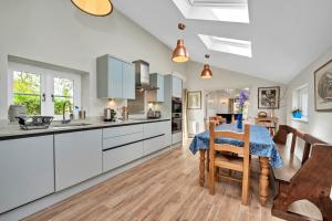 a kitchen and dining room with a table and chairs at Finest Retreats - The Pottage in Yaxley