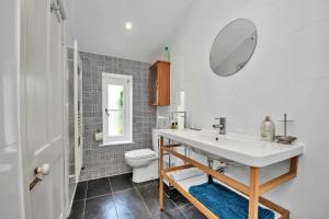 a bathroom with a sink and a toilet and a mirror at Finest Retreats - The Pottage in Yaxley +18 photos