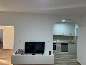 a living room with a flat screen tv on a white cabinet at DAS Apartmani Bileća in Bileća +6 photos