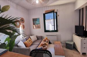 a living room with a couch and a table at Le Studio Fouesnantais in Fouesnant