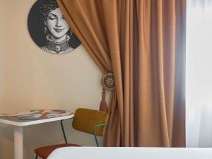 a picture of a woman behind a curtain at ibis Avignon Centre Gare in Avignon