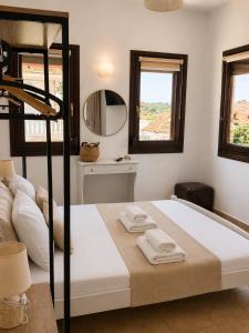 a bedroom with a bed with two towels on it at Pension Anastasia in Ammouliani