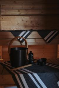 a pot on a wooden shelf in a cabin at Eurajoen opisto in Eurajoki +6 photos