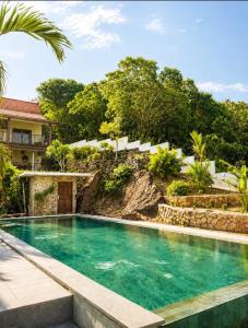 an image of a swimming pool in front of a house at Mirabelle Joglo Village in Karimunjawa