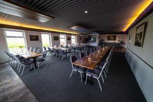 a dining room with long tables and chairs at Hotel Laxarbakki in Leirá +19 photos