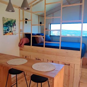 a room with a bunk bed with a table and chairs at Les nids de Bonnan in Milhars