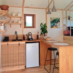 a kitchen with a white refrigerator and a counter at Les nids de Bonnan in Milhars