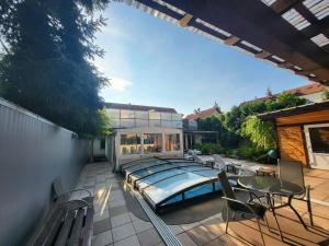 a house with a swimming pool on a patio at Hotel am Gutspark Berthold Andre und Ursula Prager GbR in Leipzig