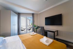 a hotel room with a bed with two towels on it at Hotel Plaza in Pag